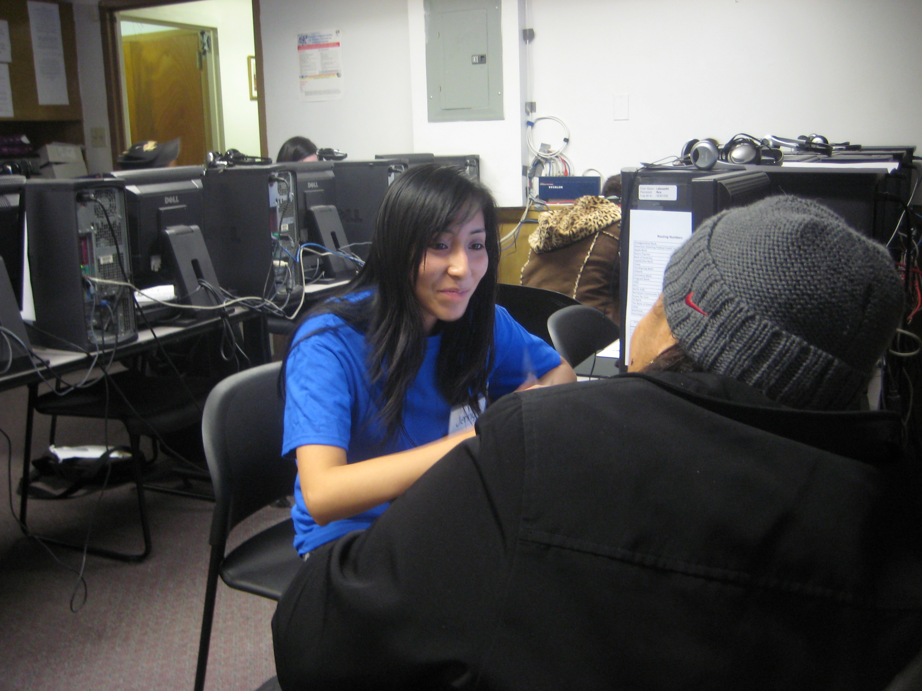 A UNHP tax volunteer explains the tax preparation process to a client.