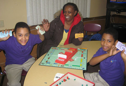 Patricia waits with her grandsons and enjoys some Monopoly.