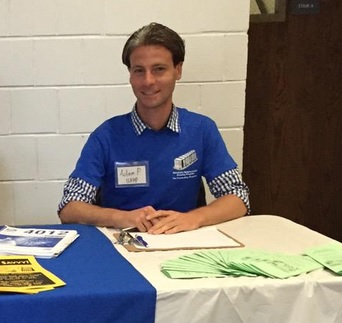 IPED Fellow Adam Pearlman mans the student volunteer booth at Lehman College. 