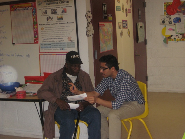 SeedCo representative Govind helps a resident navigate the healthcare information in hand.