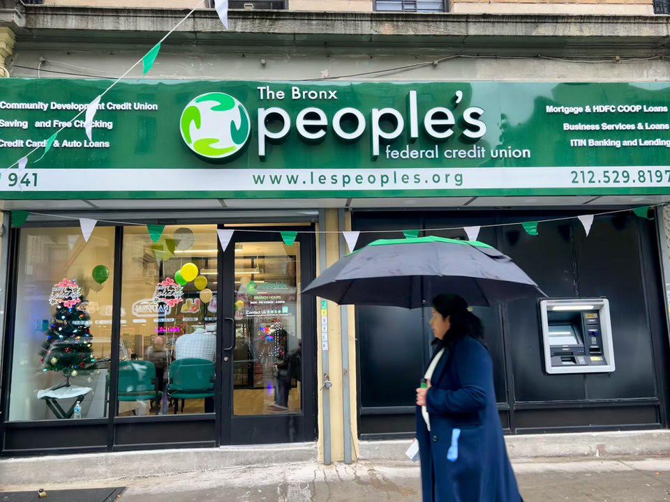 Women walks by the new Bronx People's Federal Credit Union Branch